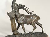 statue of a stag with antelope in its antelope ' s mouth