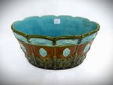 a blue and brown bowl sitting on a white surface