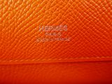 a close up view of the inside of an orange leather bag