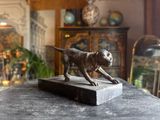 a statue of a dog that is on a table