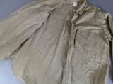 beige jacket on a table with a tag on it