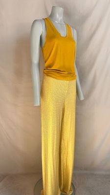 a mannequin wearing a yellow top and yellow pants