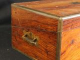 a small wooden box with a metal handle on a table