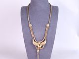 a gold necklace with a bird on it and a chain attached to it
