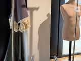 a mannequin on a stand in front of a mirror