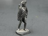 a silver statue of a man with a sword on a table