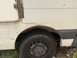a white van that is parked in the grass