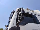 a white truck with a black grill on the front