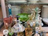 many different colored glassware on the counter top