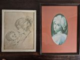 two framed pictures of a woman and a child on a table