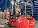 a red forklift in a warehouse with pallets in the background