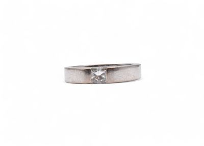 a close up of a ring with a diamond on it