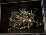 yellow and black tools are in a metal box on a table