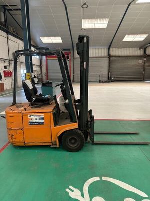 a forklift in a warehouse with a sign painted on the floor