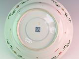 a white plate with a green and pink design on it