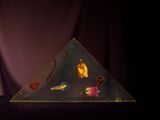 a pyramid shaped object with a variety of objects in it