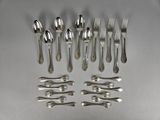 a lot of forks and spoons that are on the table