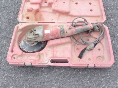 une mallette rose posée par terre, contenant des outils