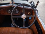 a steering wheel and dashboard of a vintage car