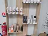 a shelf that has many different types of hair products on it