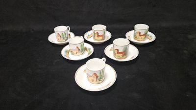 six cups and saucers with animals on them sitting on a black surface