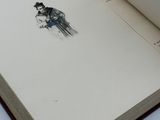 an open book with a drawing of a bird on it