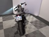 a motorcycle parked in a room with a checkered floor