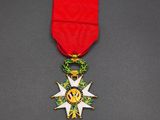 a red ribbon with a gold star on top of it