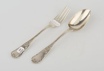 two forks and a spoon on a table with a price tag on it