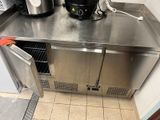 stainless steel counter top in a commercial kitchen with a coffee maker