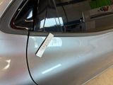 a sticker on the door of a car that is in a showroom