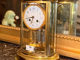 a gold clock sitting on top of a marble counter