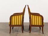 pair of yellow and brown striped chairs in a white room