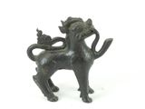 a black statue of a dog with a bird on it ' s back