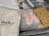 a pile of bedding that is sitting on top of a table