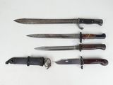 four different types of knives are lined up on a white surface
