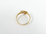 a close up of a gold ring with a green stone
