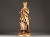 statue of a woman holding a flower in her right hand