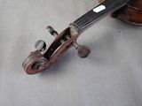 a violin that has been left on the floor
