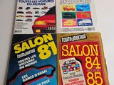 four books on a white table with a red car in front of them