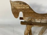 a wooden horse that is sitting on a bench