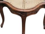 an image of a wooden bench with a wicker seat