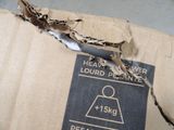 a cardboard box that has been torn open and is sitting on the floor