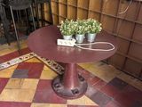 a small table with a potted plant on top of it