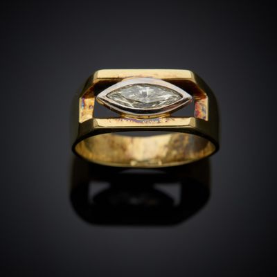 a close up of a gold ring with a diamond in the center