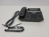 a telephone and a cord on a white table