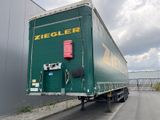 a large green truck that is parked on the side of the road