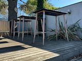a wooden deck with a table and chairs on it