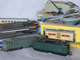 several toy trains are lined up on a table next to a box