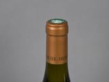 the bottle of wine is sitting on the table ready to be eaten